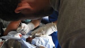 AMEDICAusa volunteer Efim Oykhman repairs a machete wound