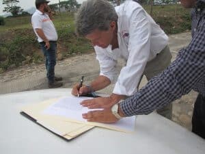 AMEDICAusa signing the final paperwork for housing construction for the survivors of Volcán Fuego